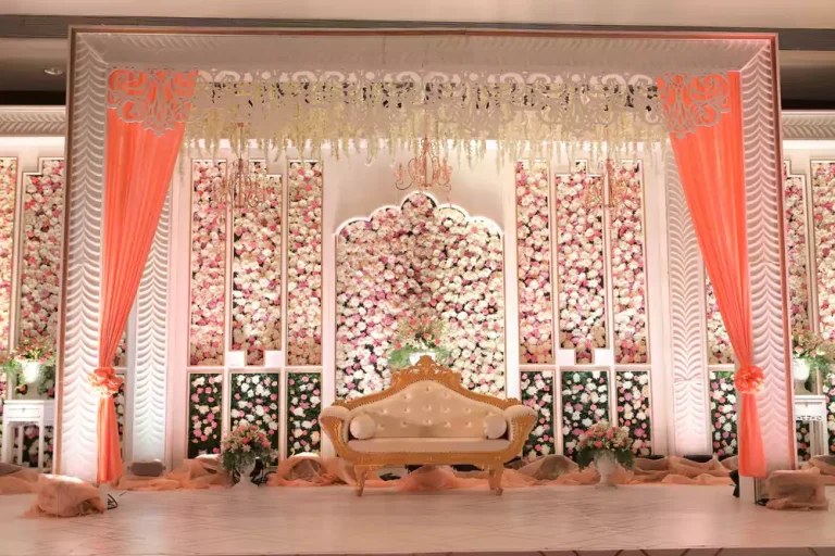 Luxury wedding stage decorated with flowers and lights.