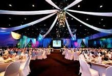 Indoor stage decorated with lights and drapes.